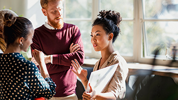 woman-presenting-to-colleagues